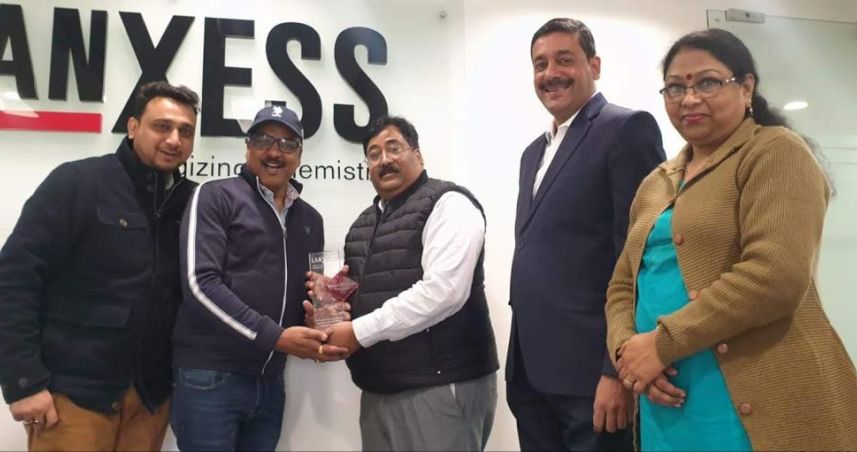 Mahesh Manglesh receiving the LANXESS sales performance award — long-standing recognition from global polymer suppliers