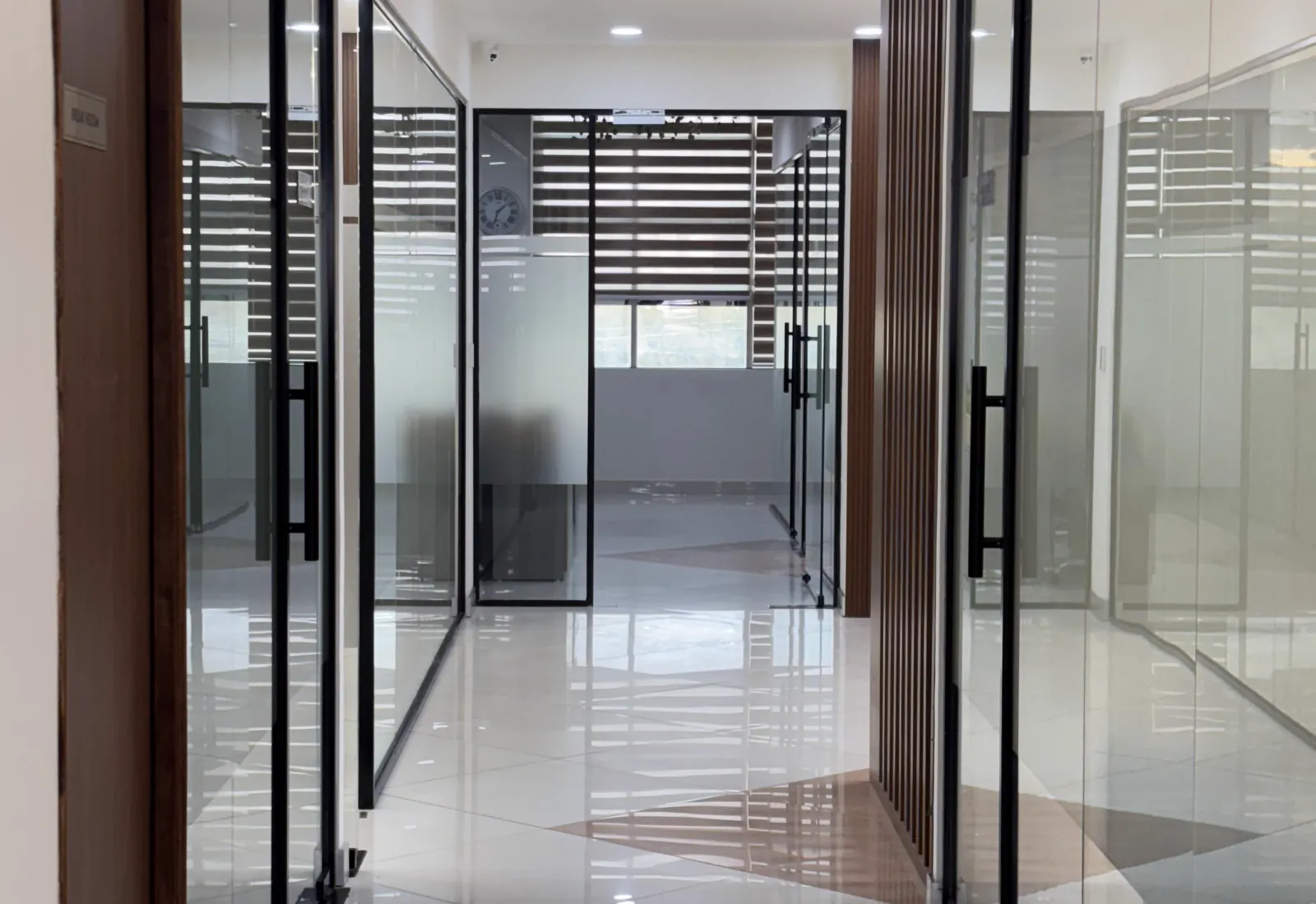 Glass-lined corridor inside the Faridabad office